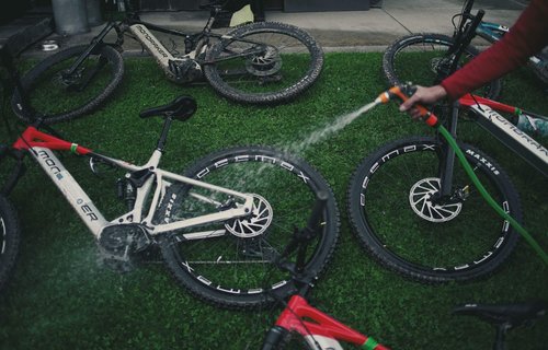 A-Slow-Cyclist-guide-hosing-down-bikes-on-Via-Transilvanica-expedition