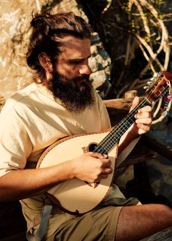 A-Slow-Cyclist-guide-playing-the-lyra-in-Crete-Greece