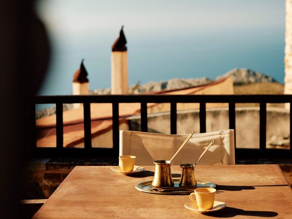 Coffee-overlooking-the-town-on-a-Slow-Cyclist-journey-in-Crete-Greece-landscape