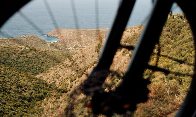 Looking-over-the-sea-through-a-bike-wheel-Slow-Cyclist-in-the-Mani-Greece