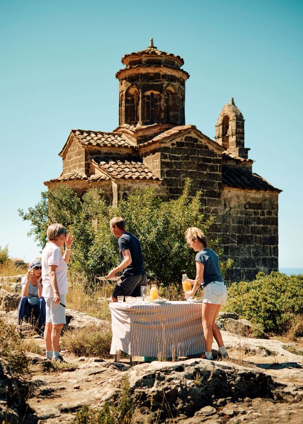 Slow-Cyclists-taking-a-break-by-church-Mani-Greece